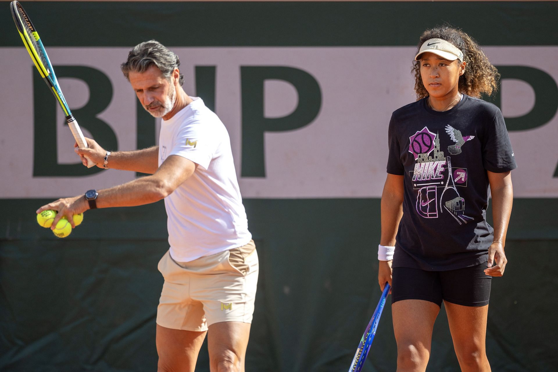 Naomi Osaka trains with coach Patrick Mouratoglou ahead of the 2025 French Open. Source: Getty